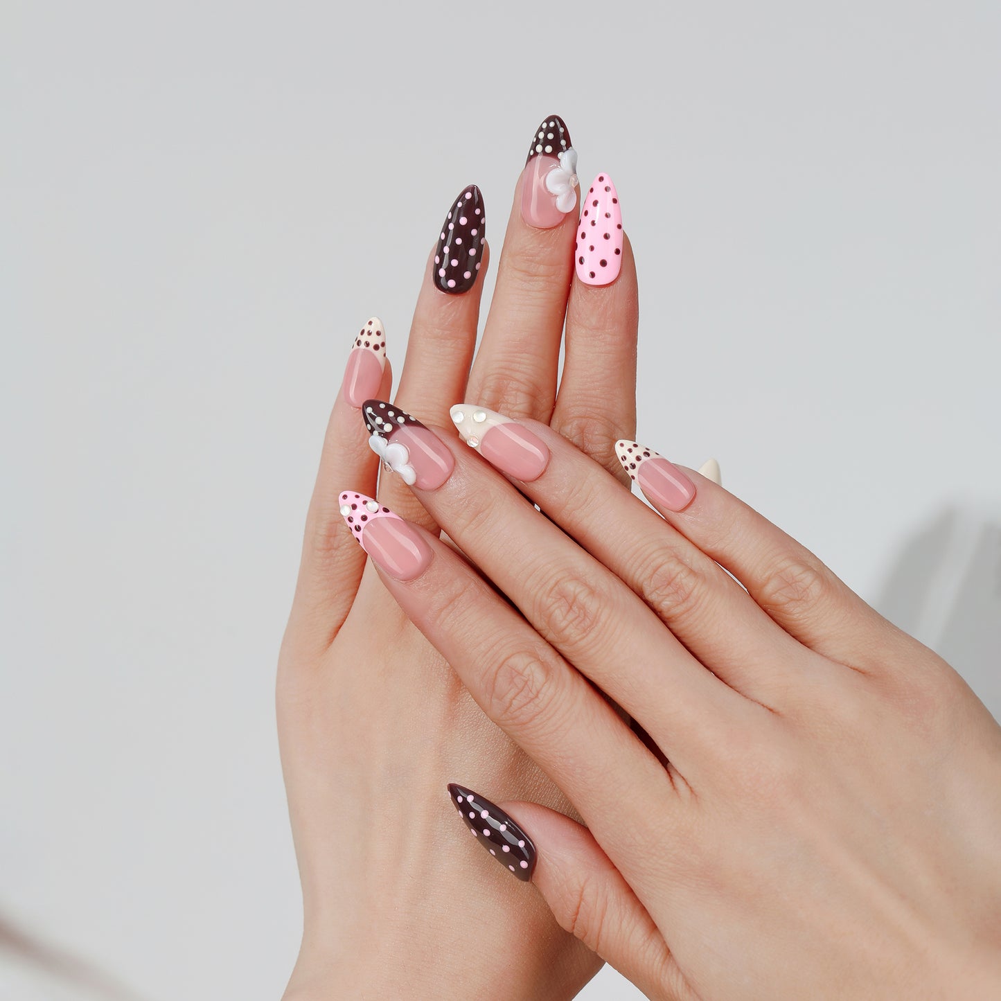 Polka Bloom almond press-on nails hand close-up