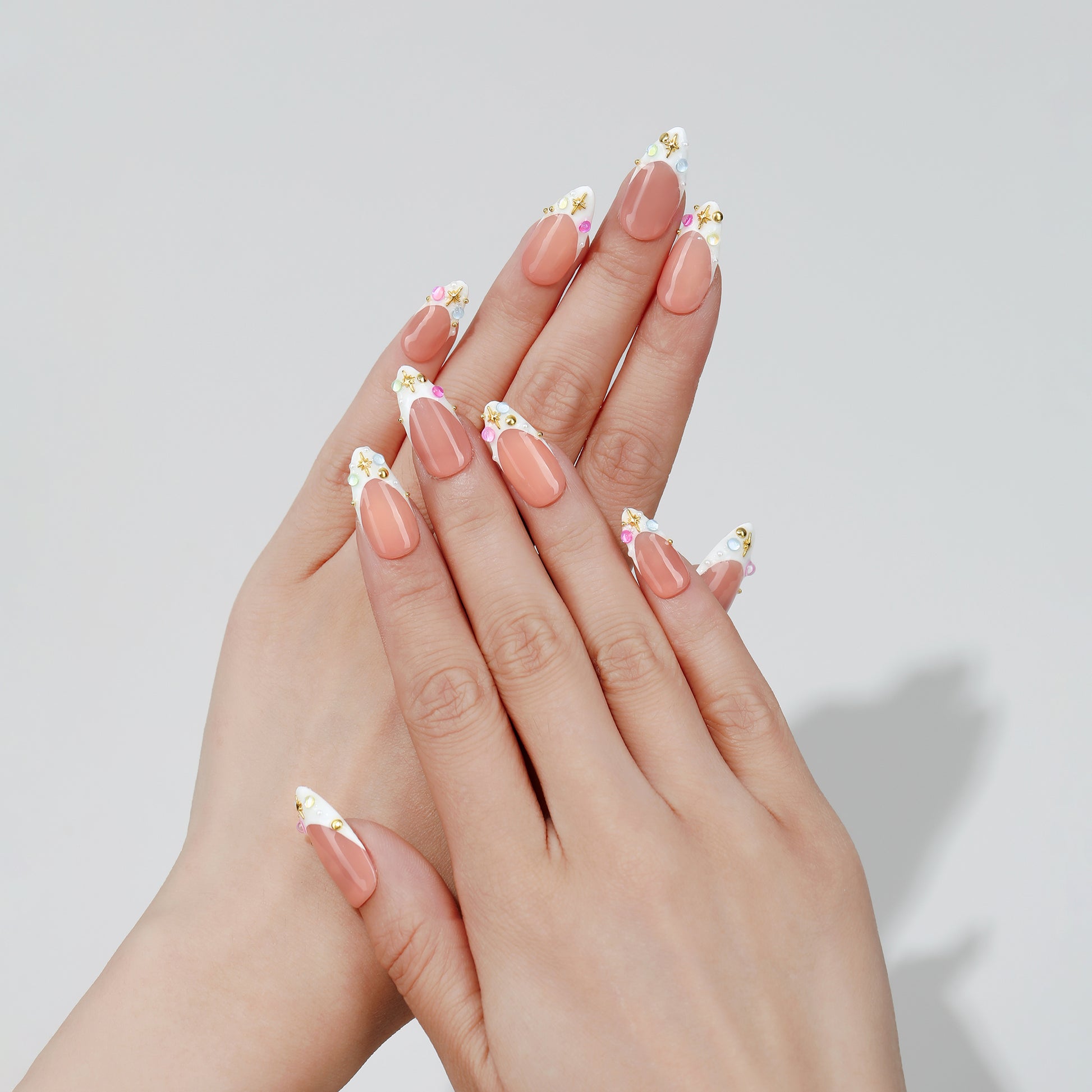 Multicolor Rhinestones almond press-on nails worn on hand