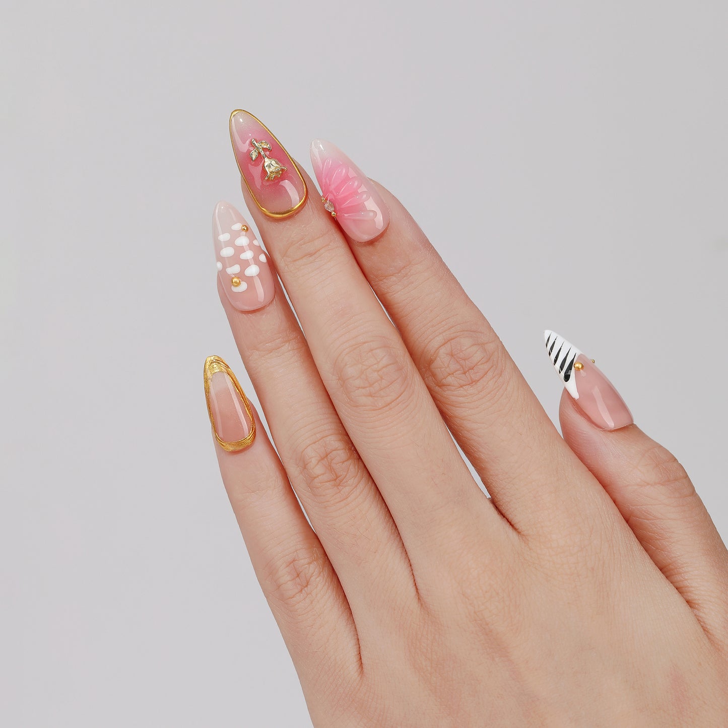 Blush Stripe almond press-on nails worn on hand
