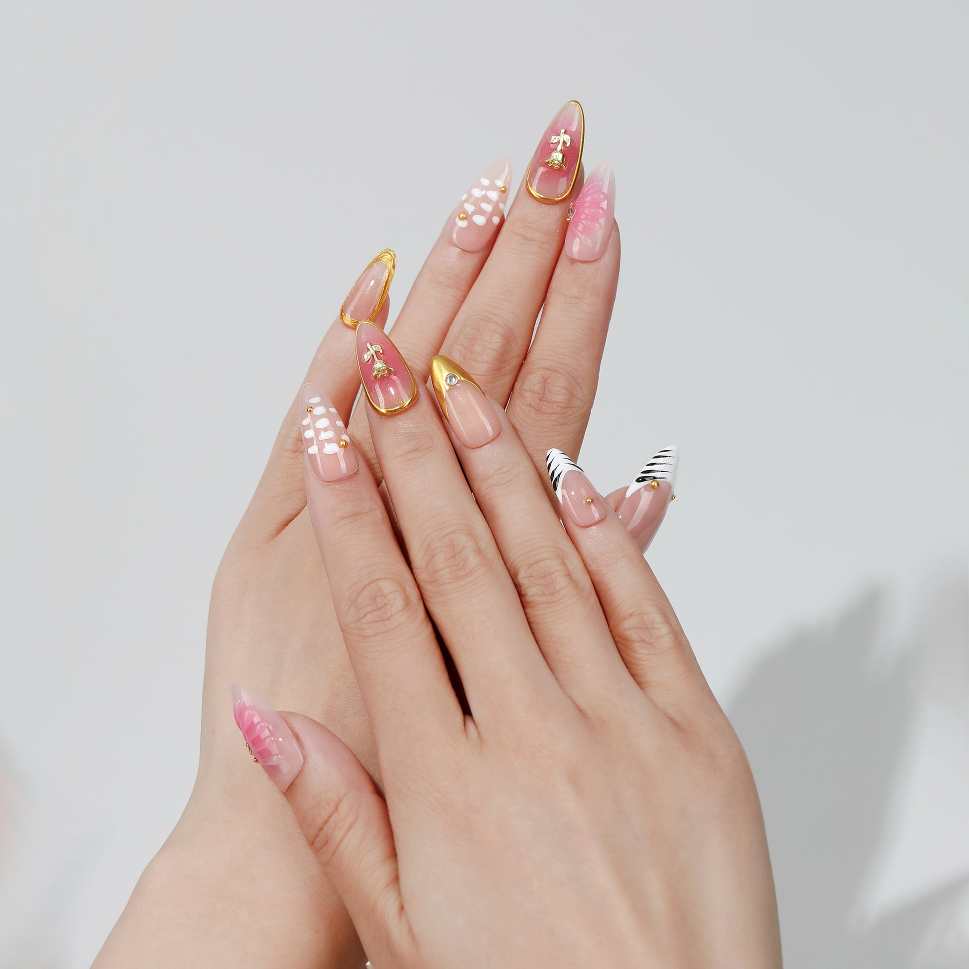 Blush Stripe almond press-on nails hand close-up