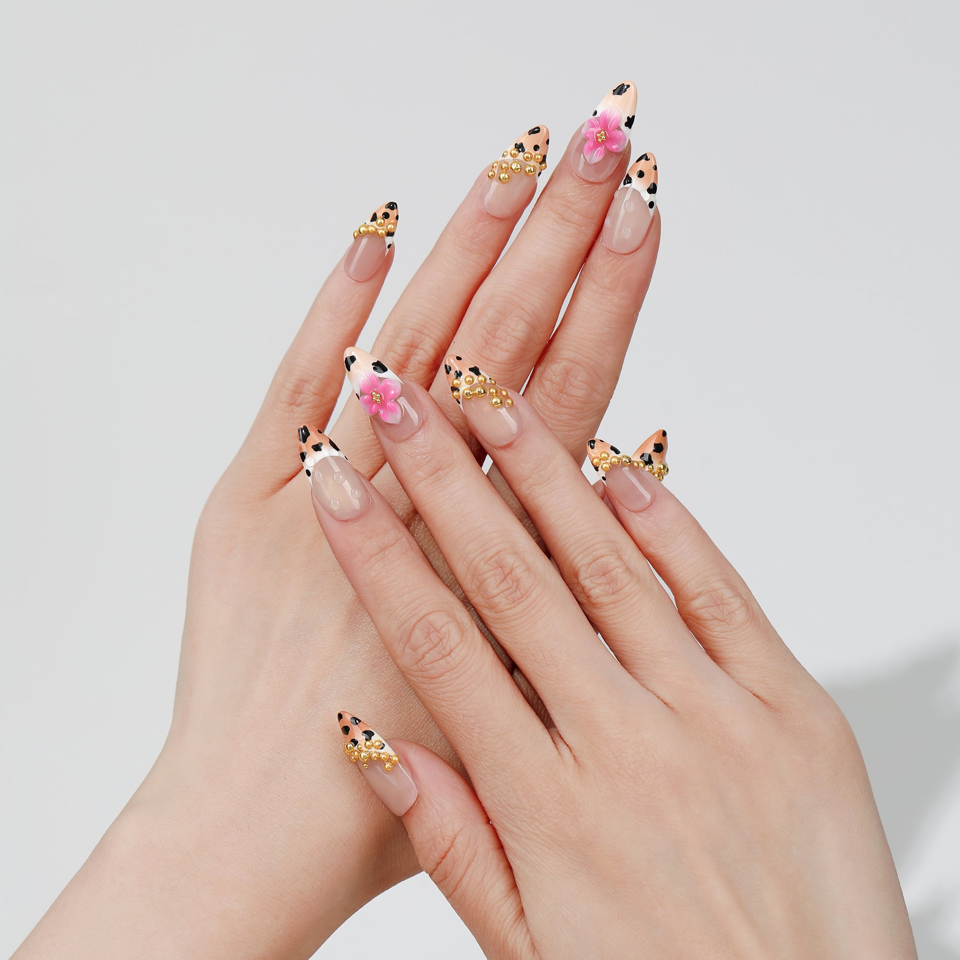 Spotted Garden almond press-on nails worn on hand