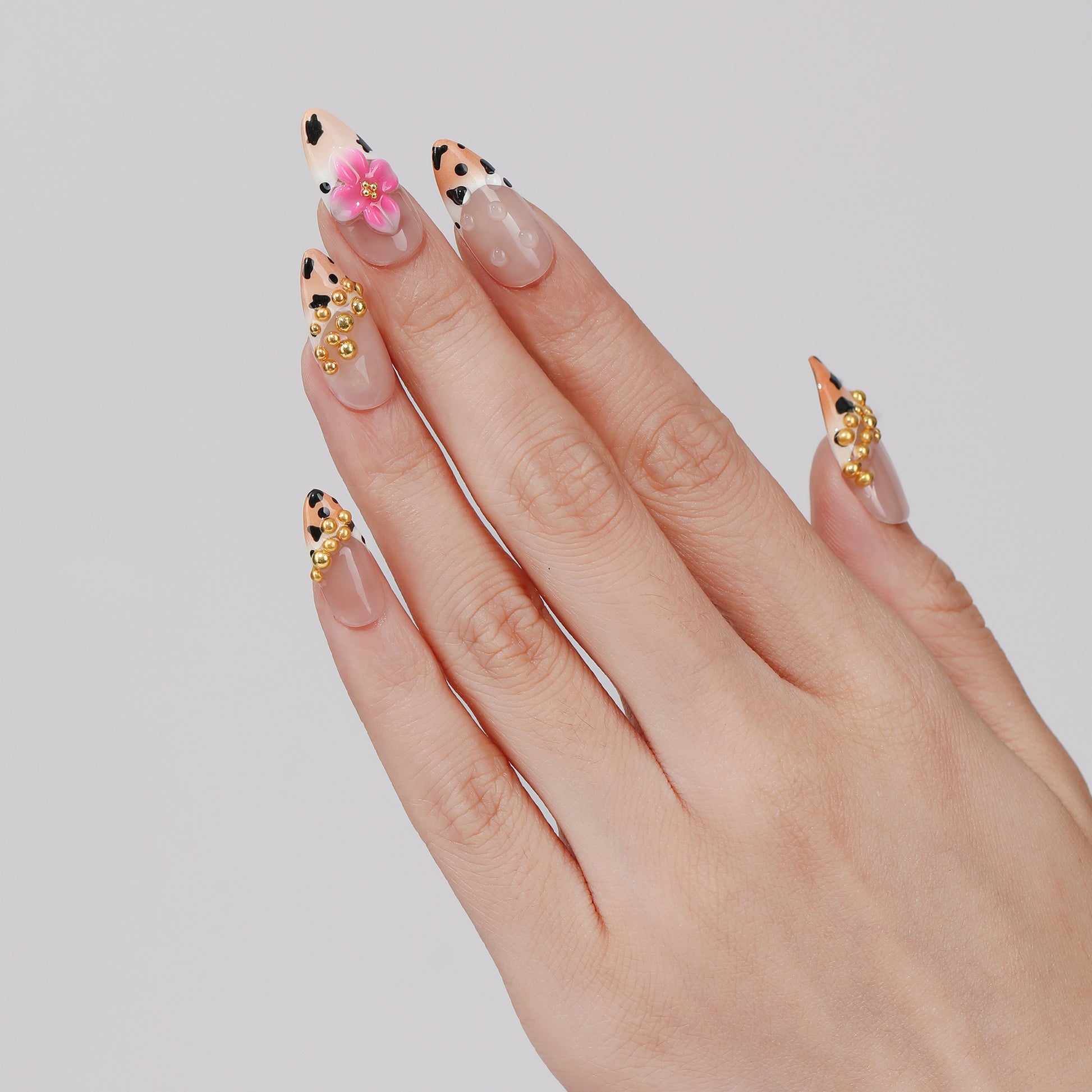 Spotted Garden almond press-on nails hand close-up