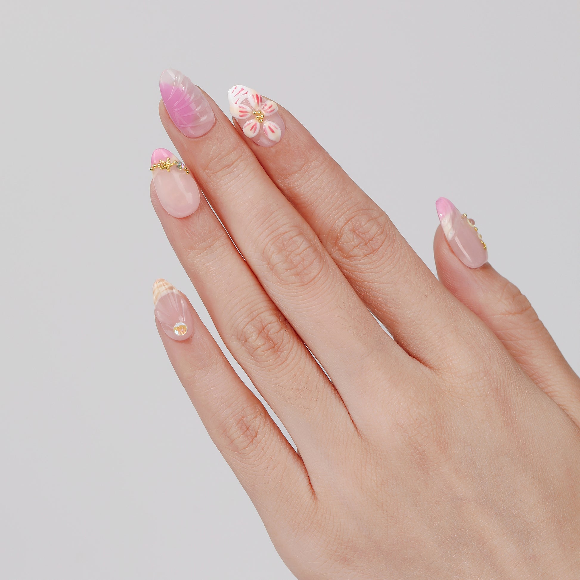 Pink Meadow short almond press-on nails hand close-up