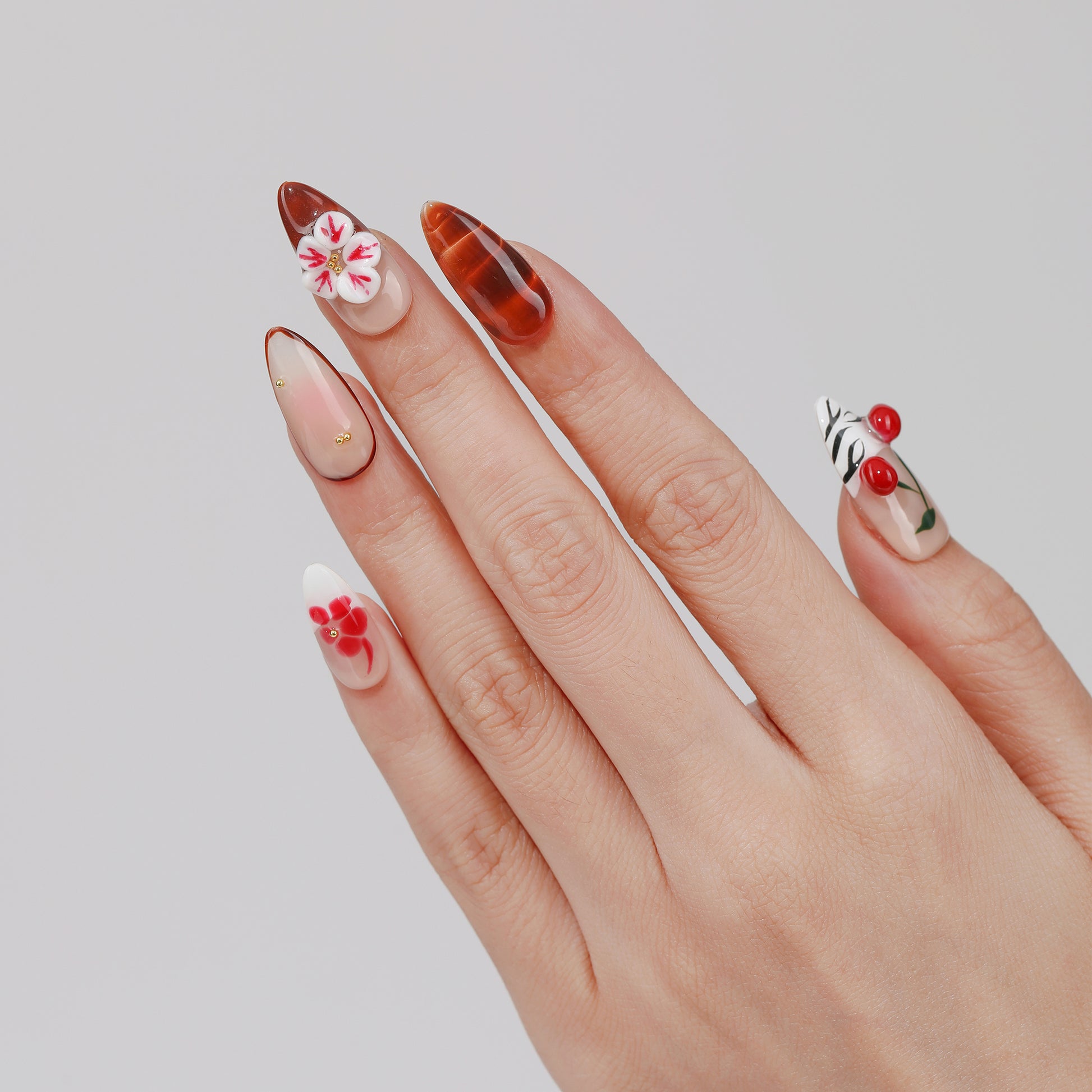 Cherry Blossom almond press-on nails worn on hand
