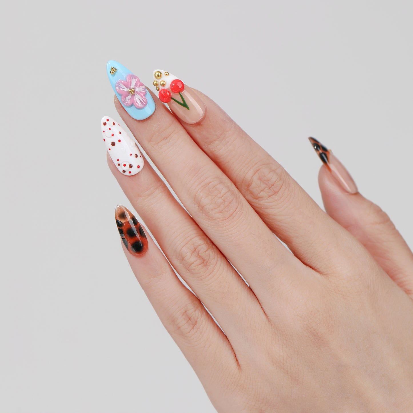 Cherry Cloud almond press-on nails worn on hand