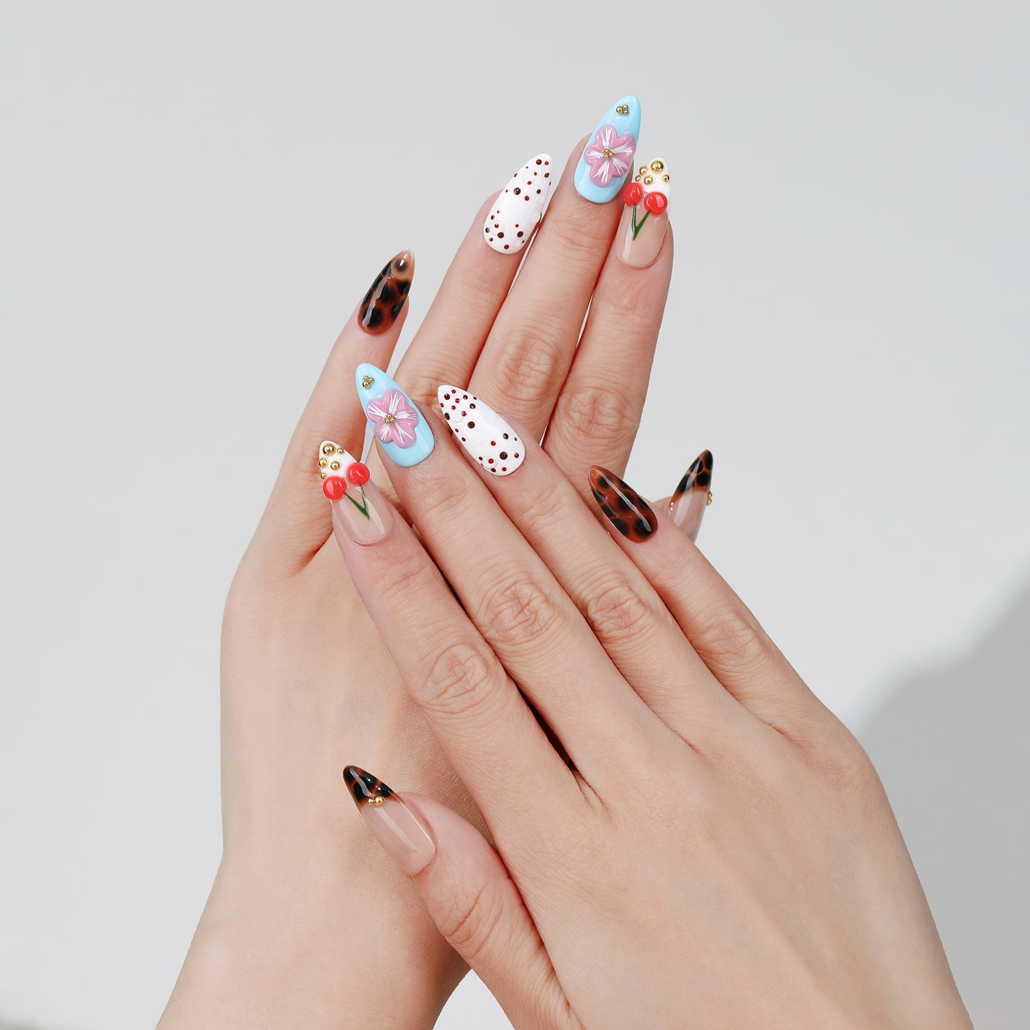 Cherry Cloud almond press-on nails hand close-up