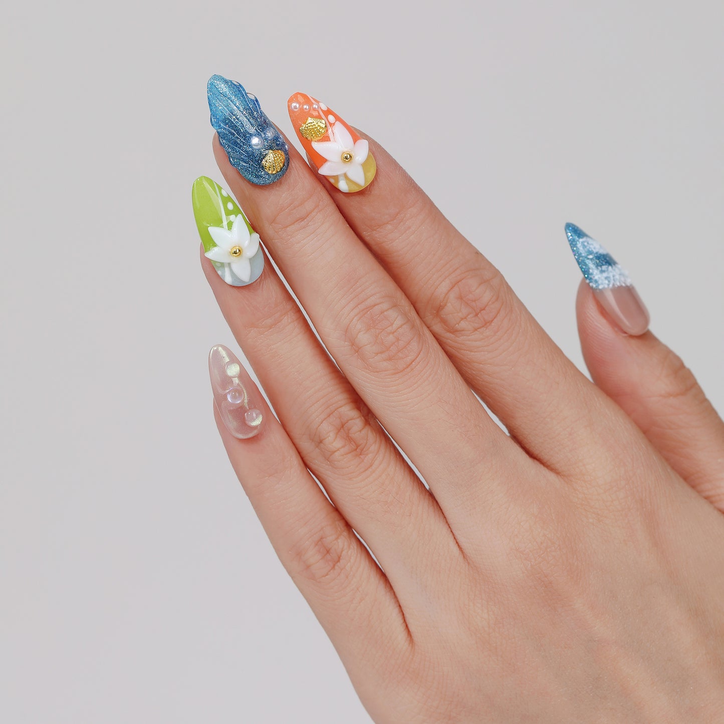 Ocean Breeze almond press-on nails worn on hand