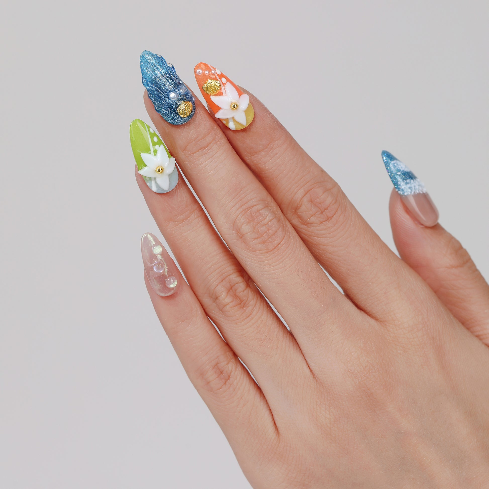 Ocean Breeze almond press-on nails worn on hand