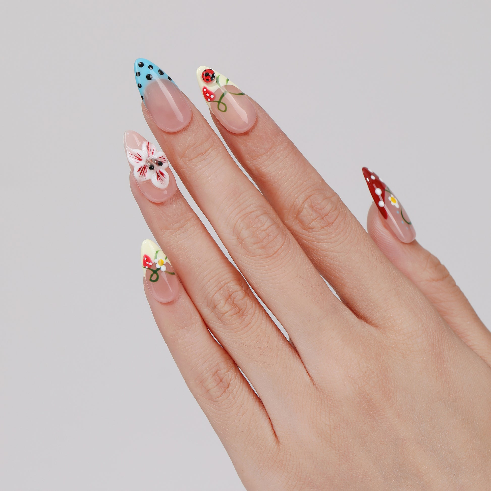 Confetti Daisy almond press-on nails worn on hand