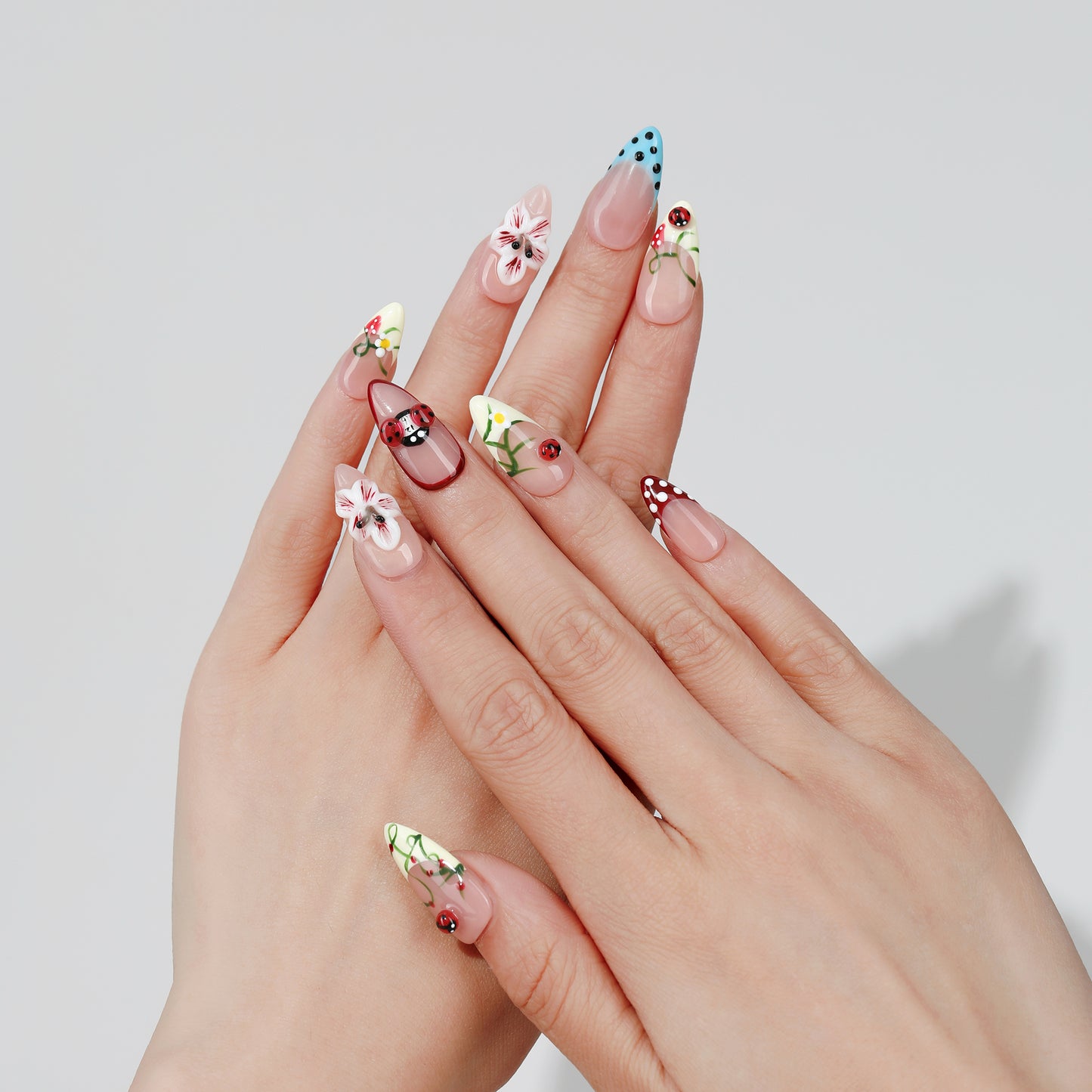 Confetti Daisy almond press-on nails hand close-up