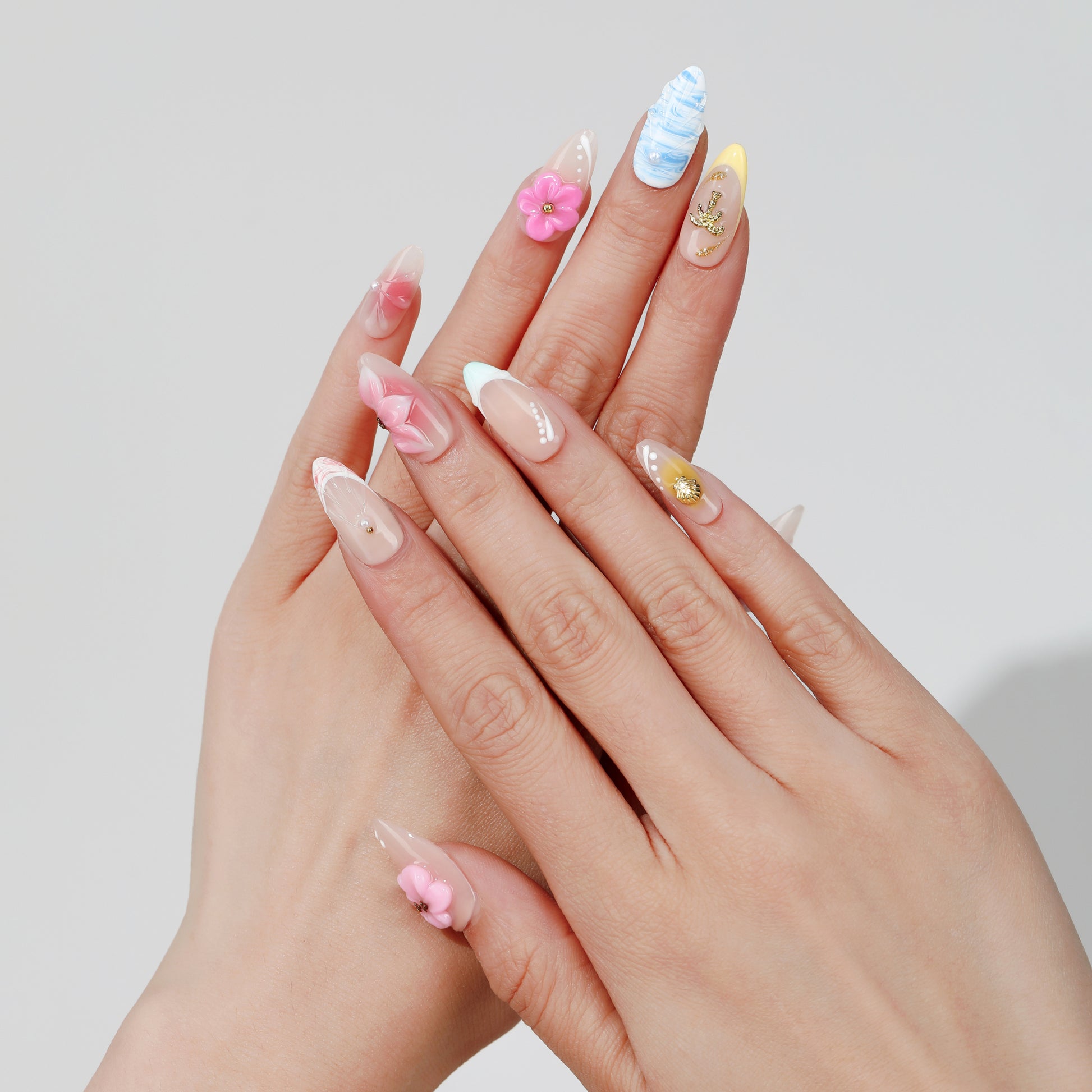 Rainbow Petal almond press-on nails worn on hand
