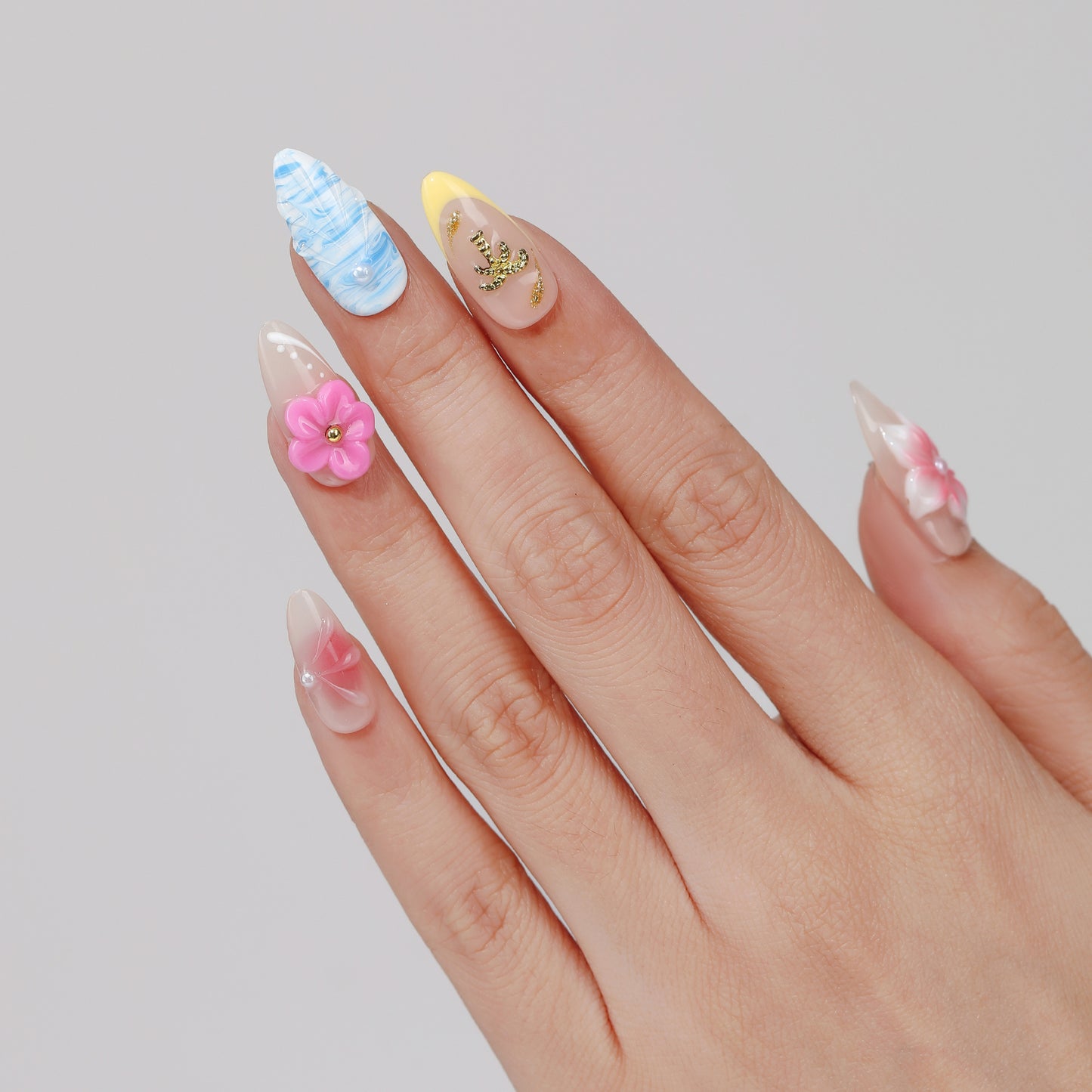 Rainbow Petal almond press-on nails hand close-up