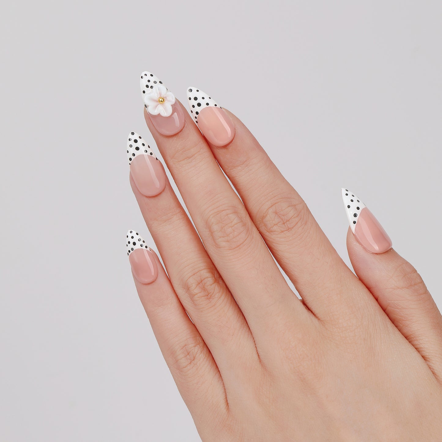 Duo Dot almond press-on nails worn on hand