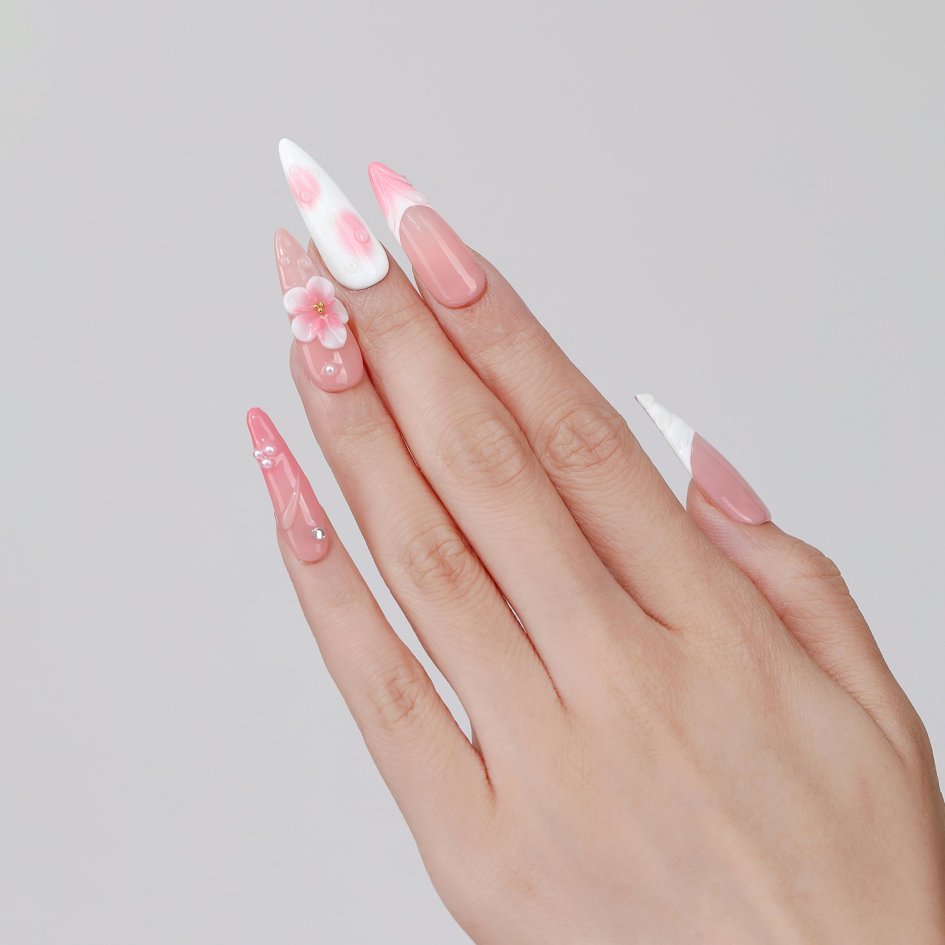 Fading Petal long almond press-on nails hand close-up