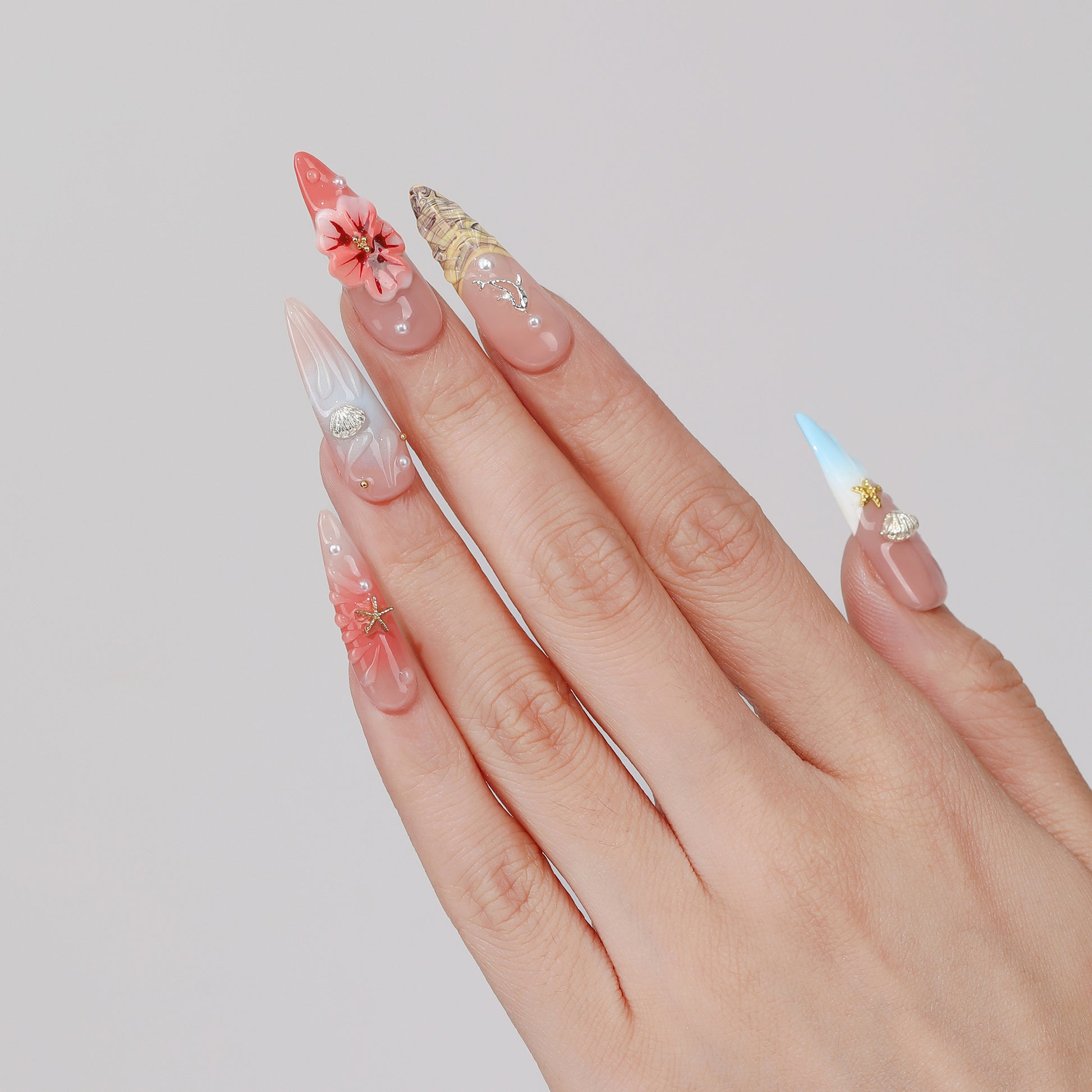 Blush Trail long almond press-on nails hand close-up