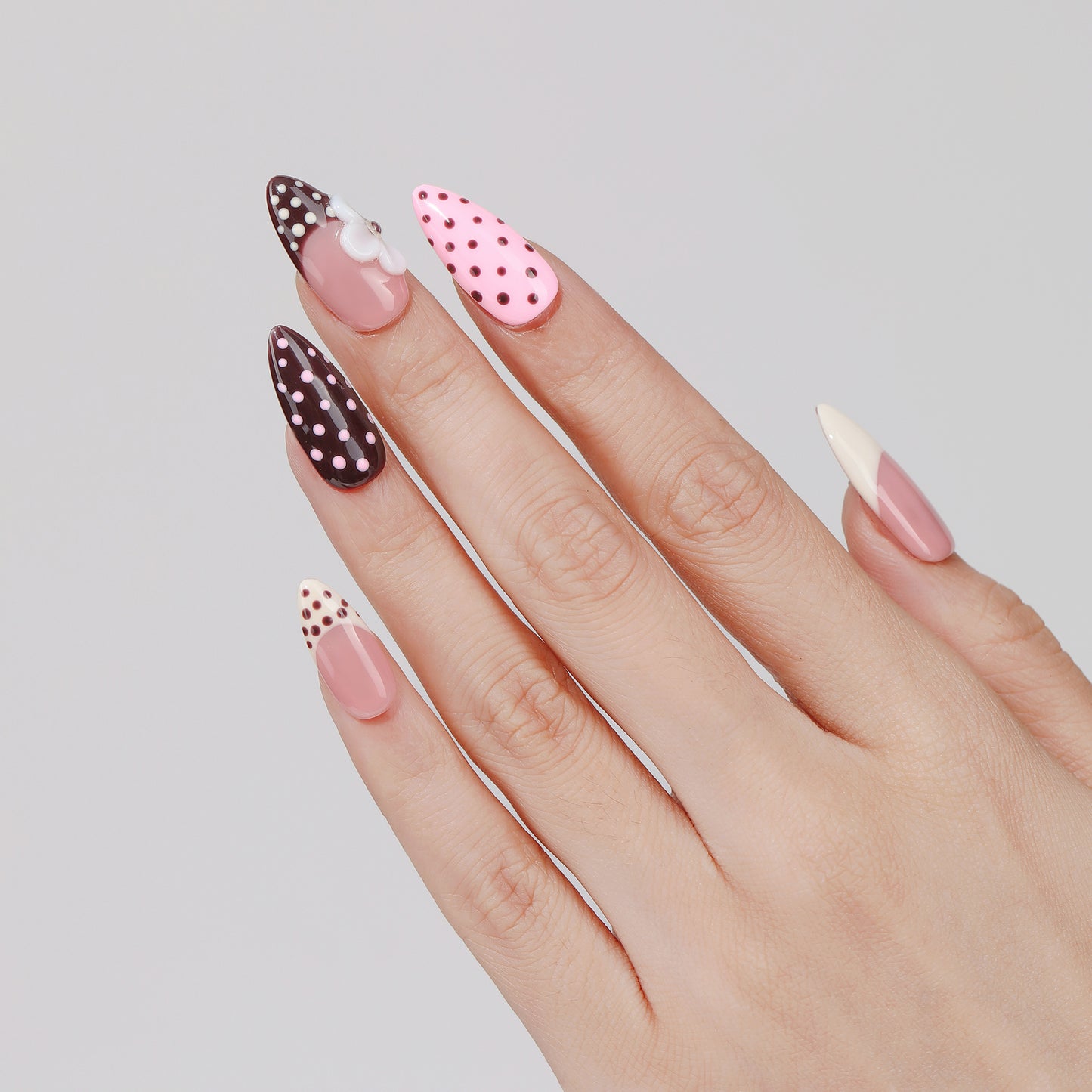 Polka Bloom almond press-on nails worn on hand