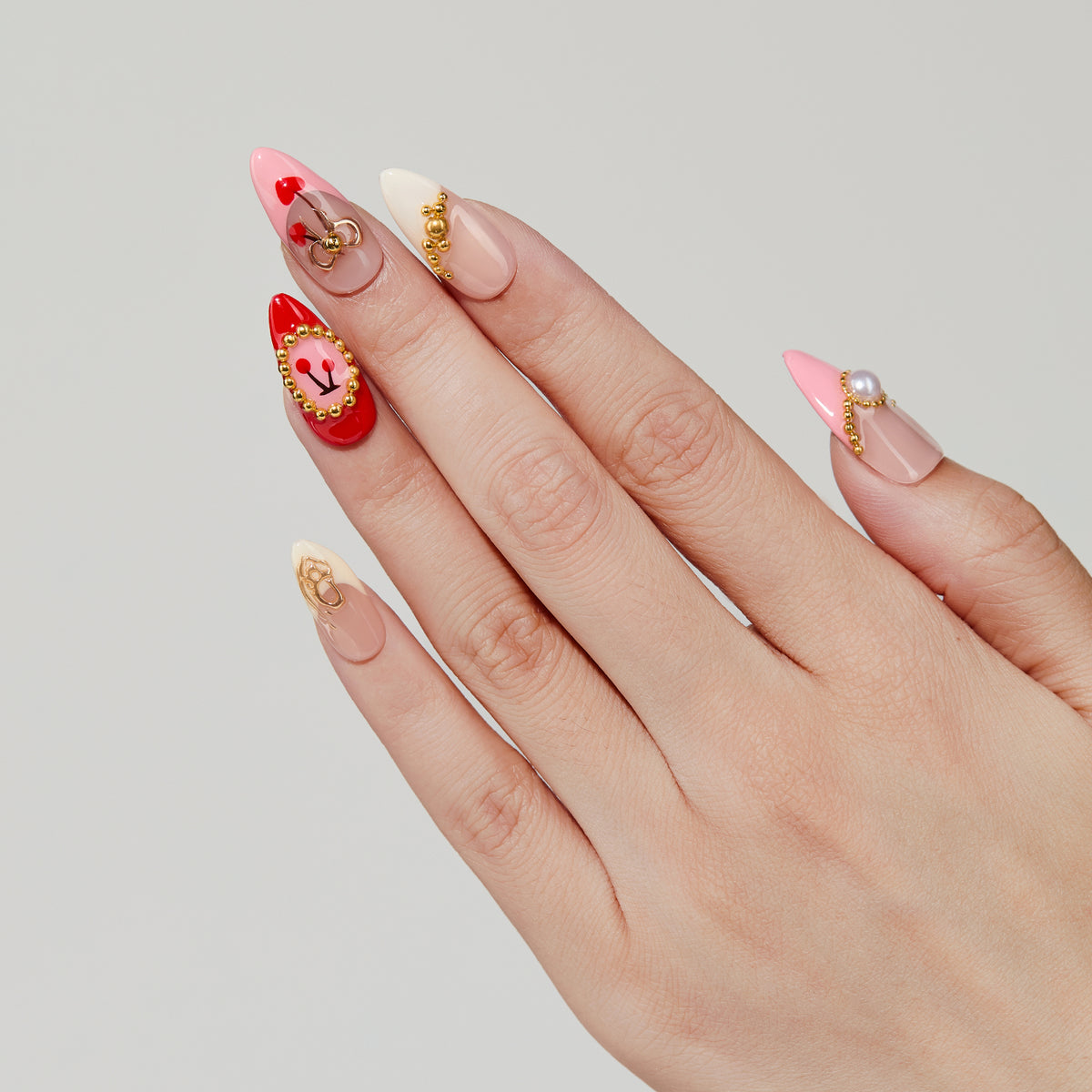 Cherry Luxe almond press-on nails worn on hand