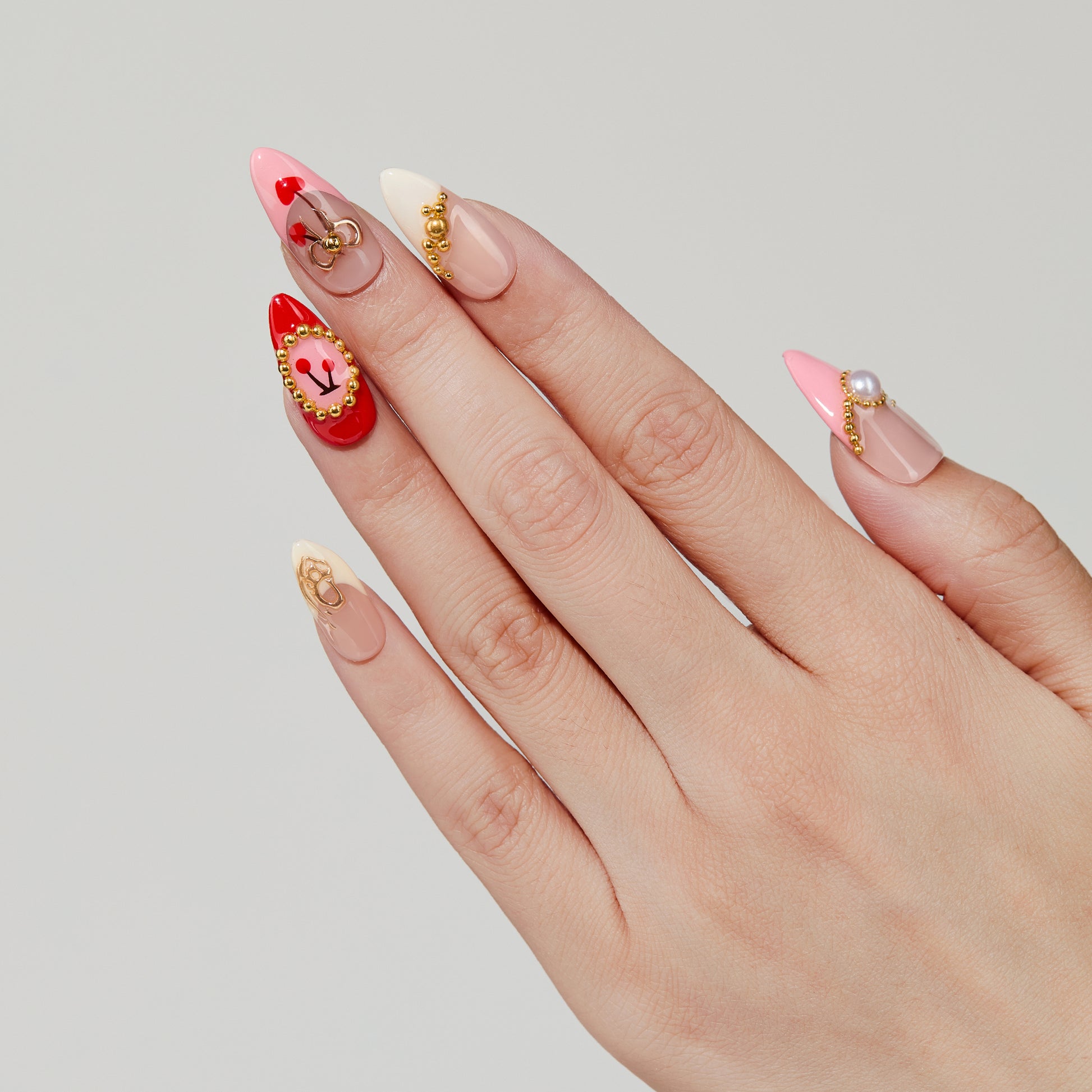 Cherry Luxe almond press-on nails worn on hand