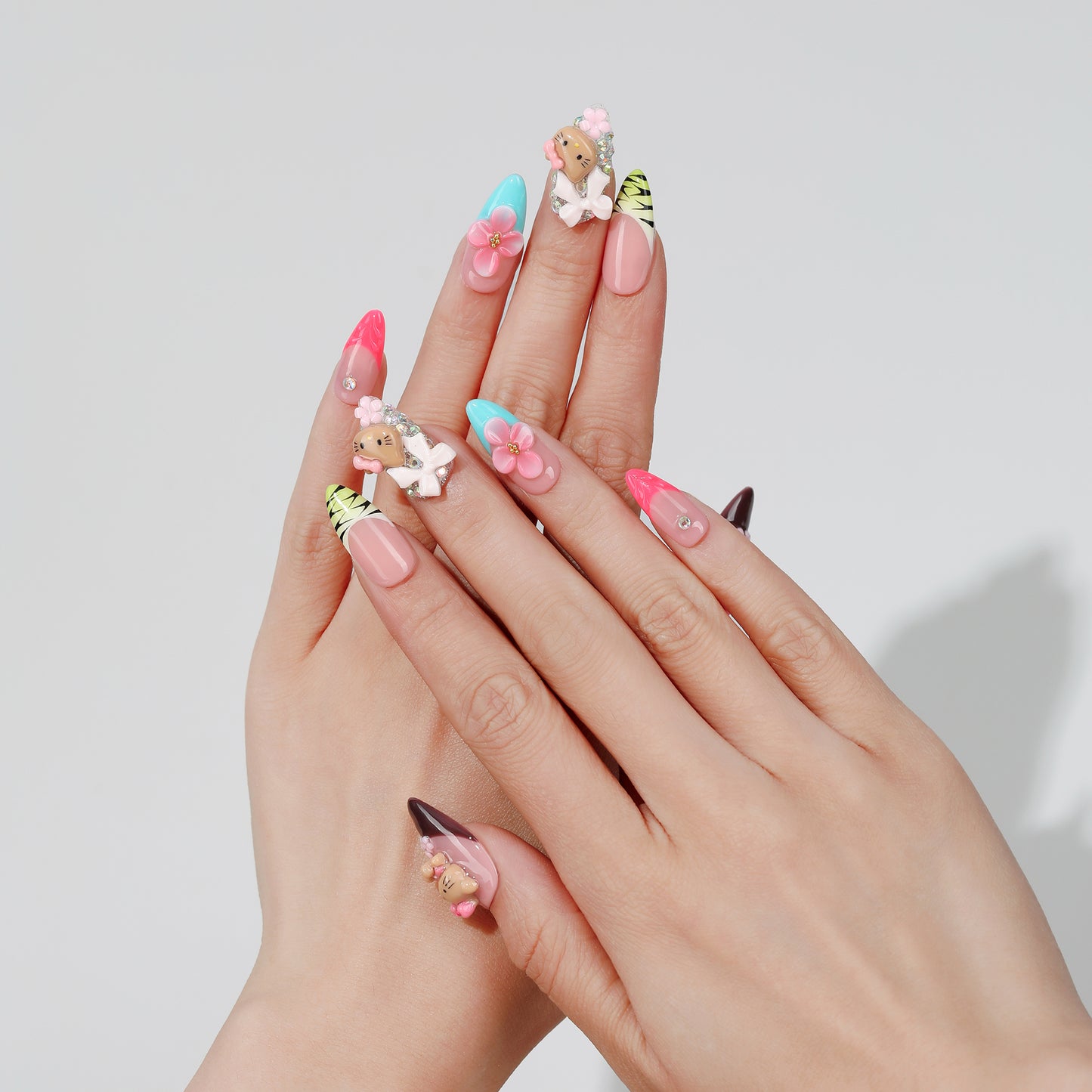Kitty Garden almond press-on nails worn on hand