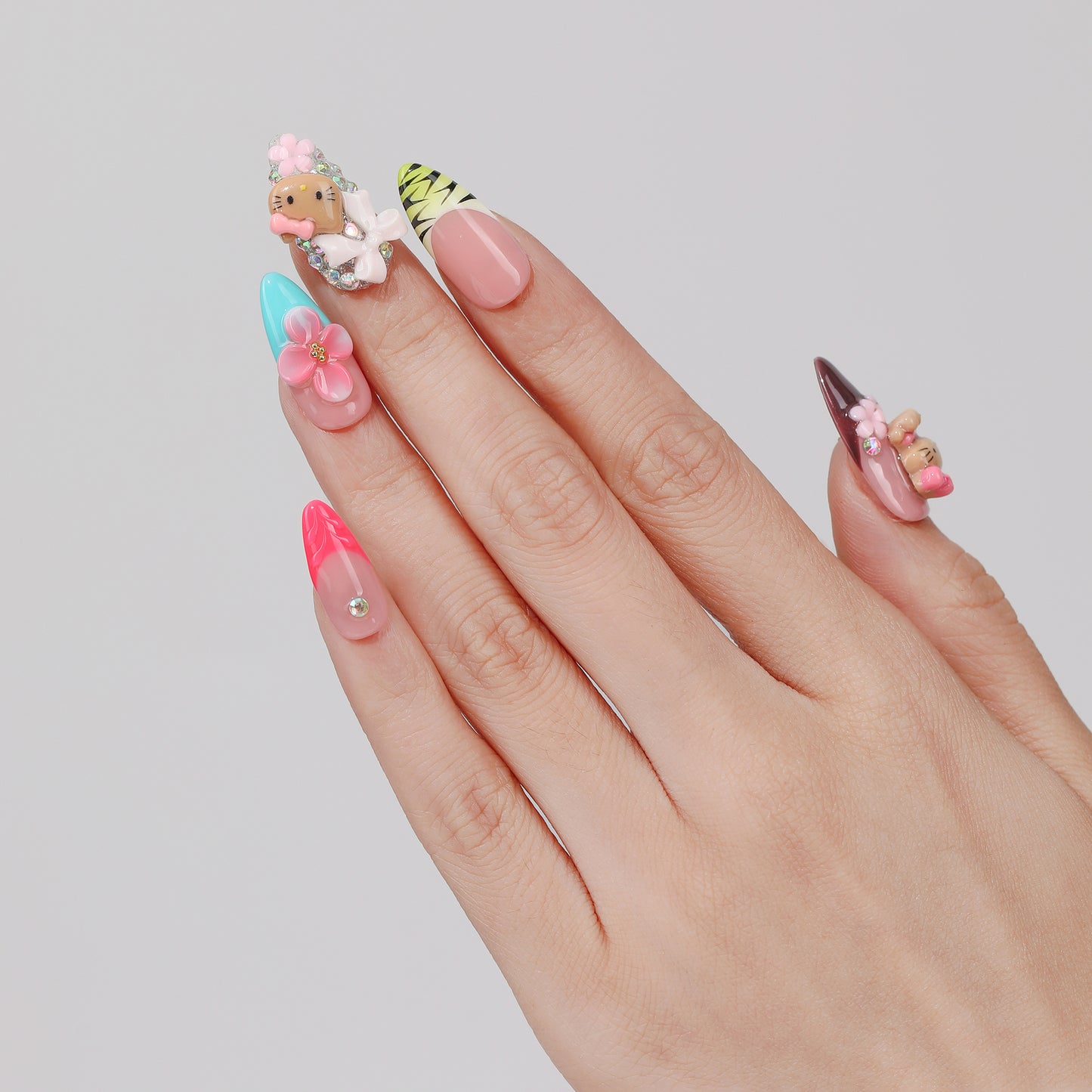 Kitty Garden almond press-on nails hand close-up