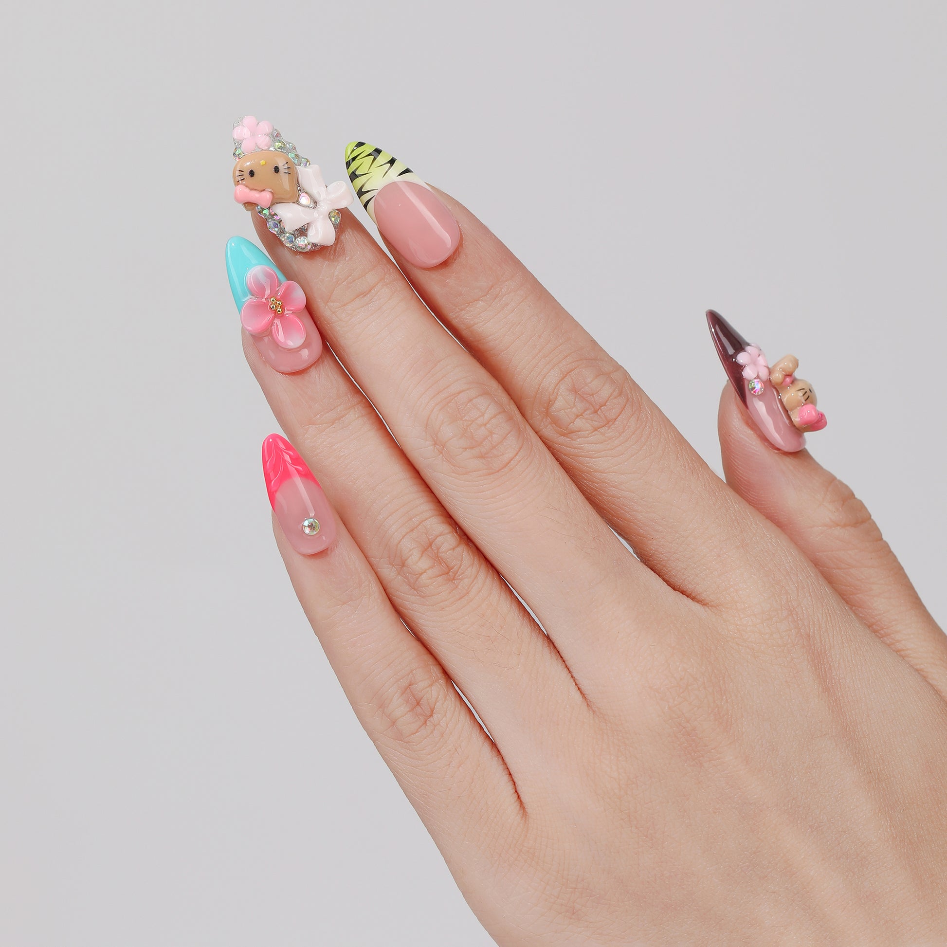 Kitty Garden almond press-on nails hand close-up