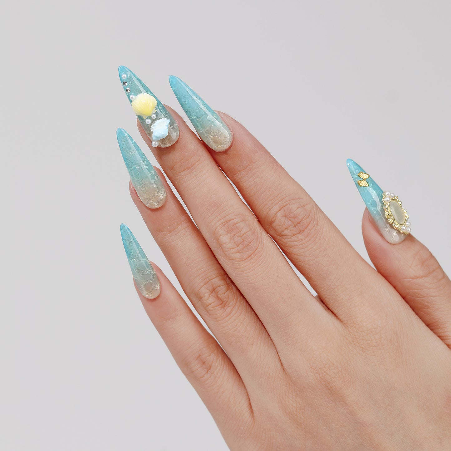 Moonlit Shell stiletto press-on nails worn on hand