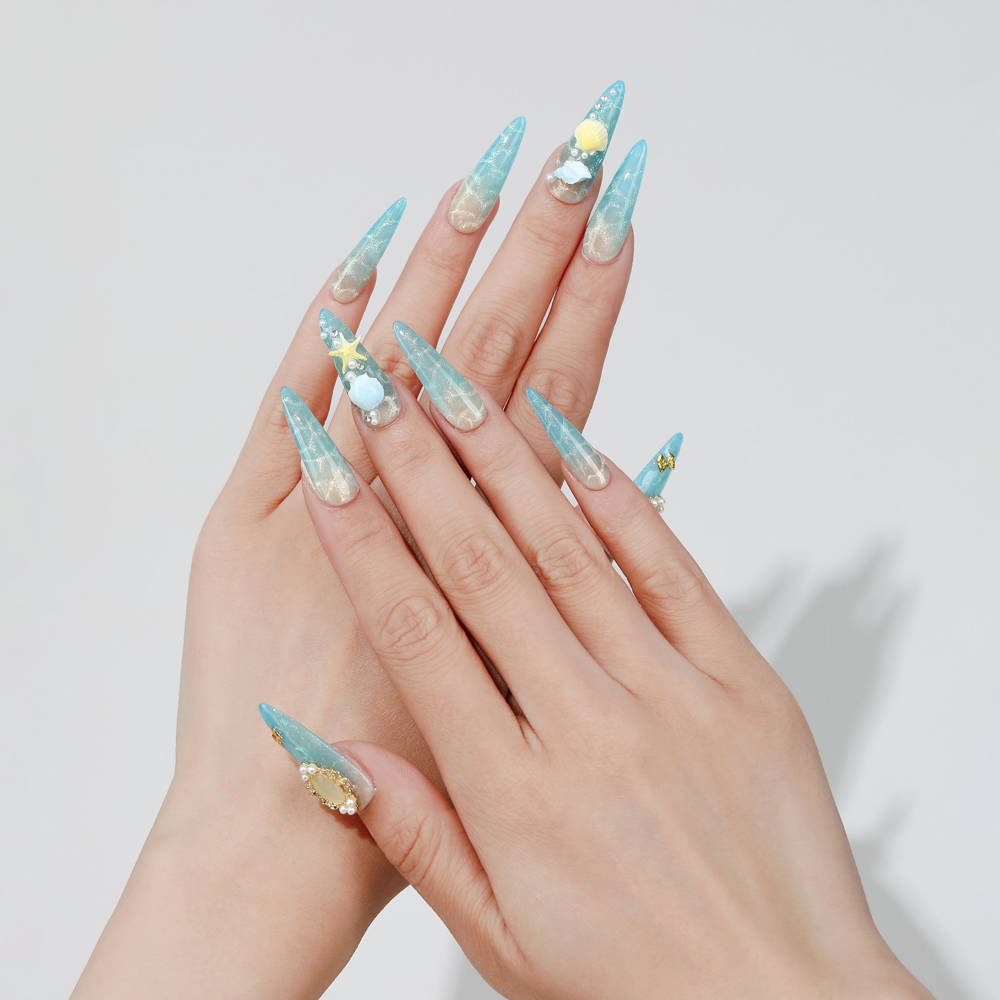 Moonlit Shell stiletto press-on nails hand close-up