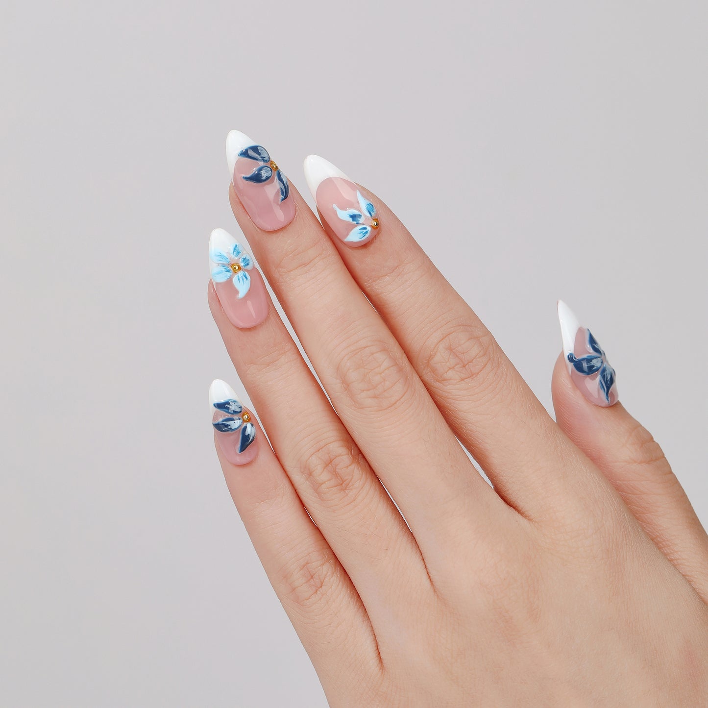 Blue Peony almond press-on nails worn on hand