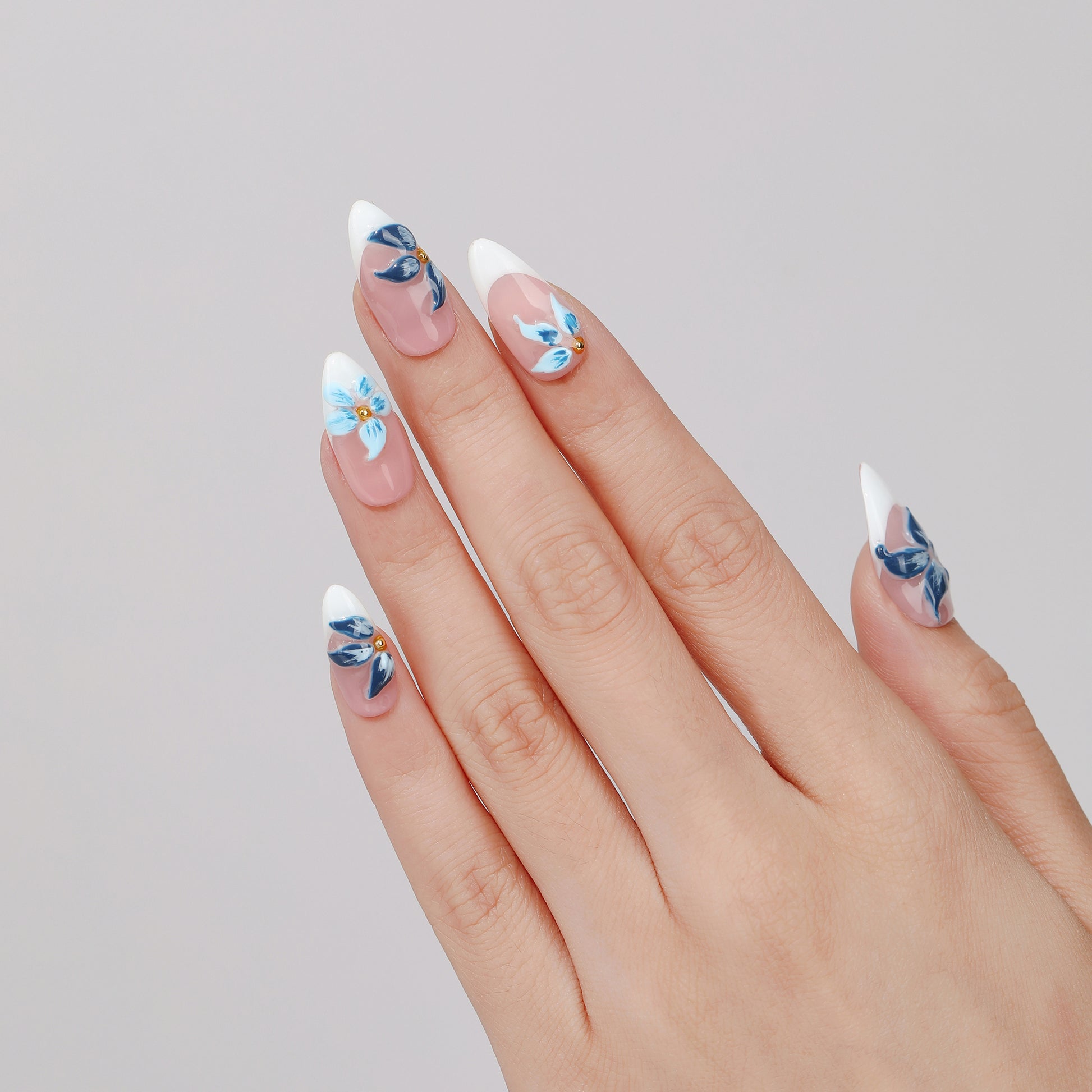 Blue Peony almond press-on nails worn on hand