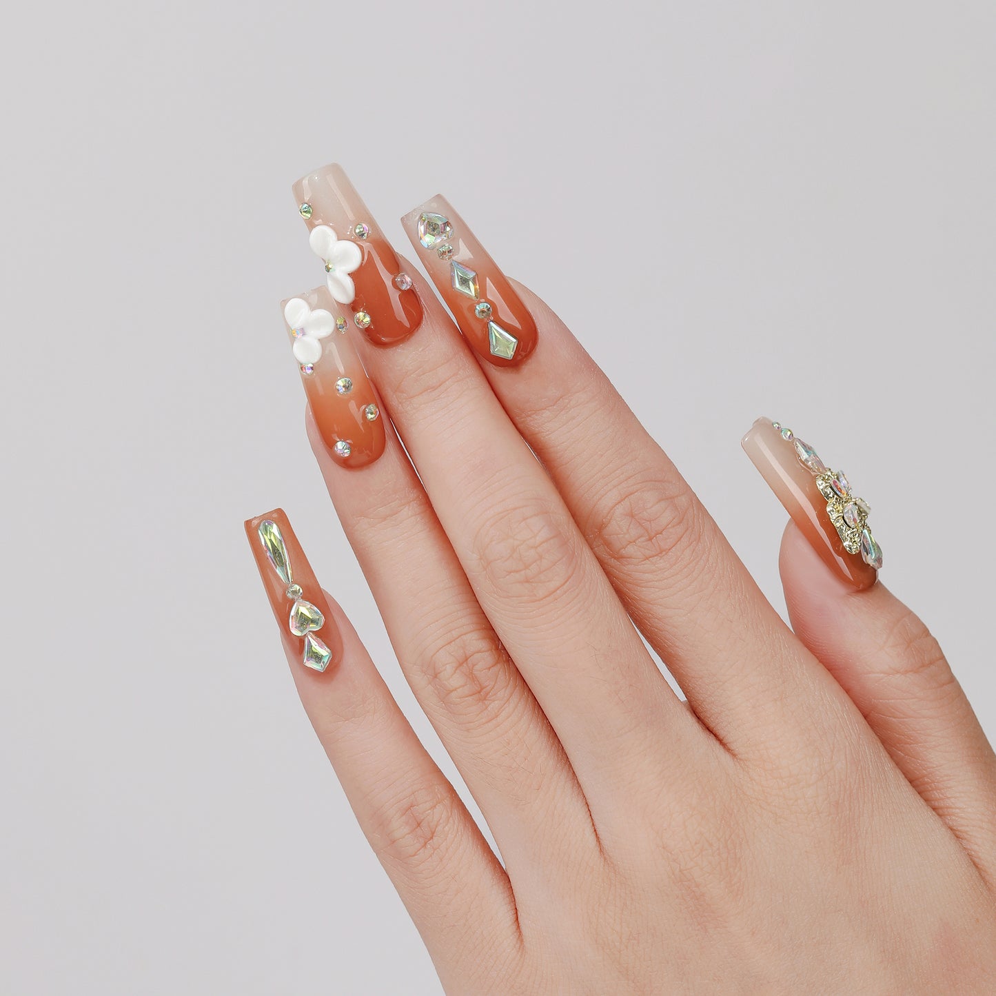 Amber Flora square press-on nails hand close-up